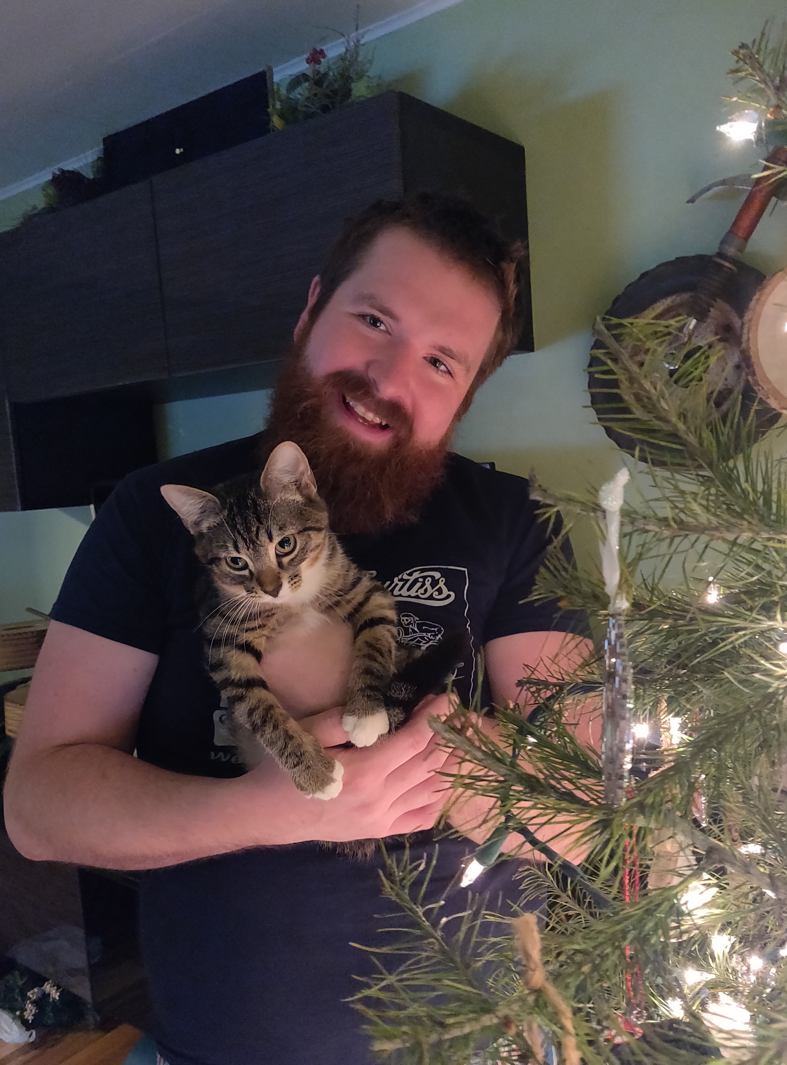 Friendly mad with big smile holding a kitten